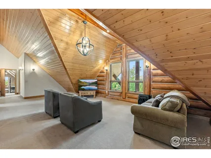 a view of a bedroom with wooden floor