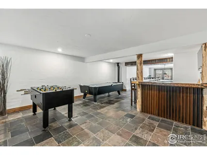 a living room with furniture a ceiling fan and a rug