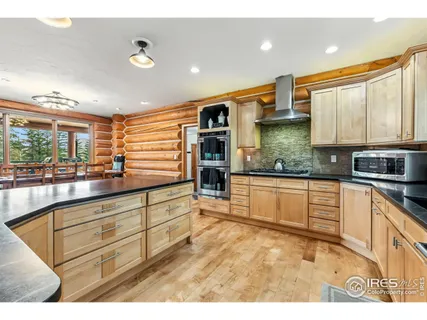 a kitchen with stainless steel appliances granite countertop a stove and a sink