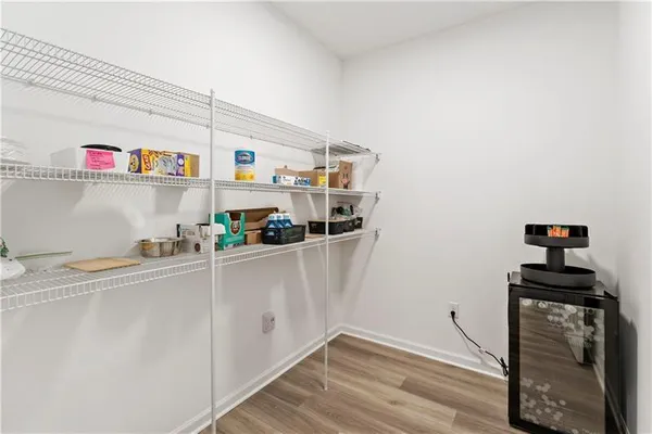 a kitchen with a refrigerator and a stove top oven