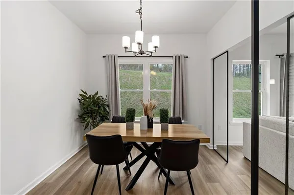 a view of a dining room with furniture window and wooden floor
