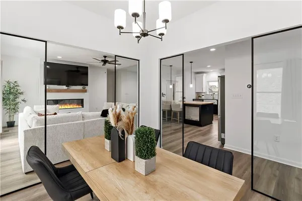 a dining room with furniture and a potted plant