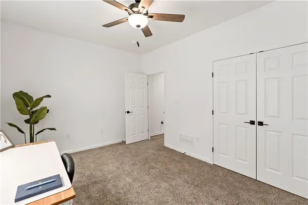 a view of room with a ceiling fan
