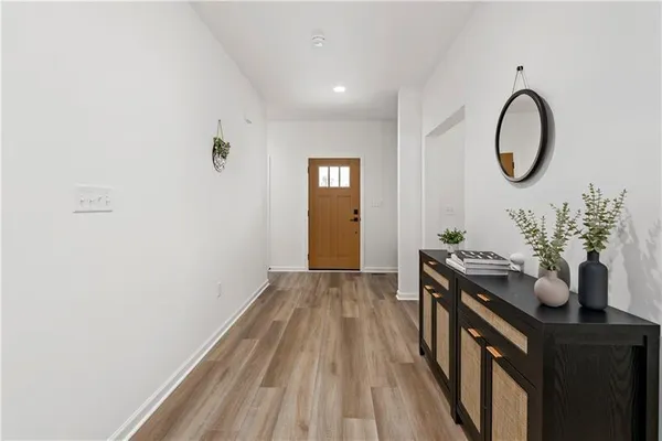 a kitchen with a sink and a wooden floor