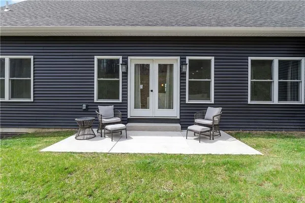 a front view of a house with a garden and sitting area