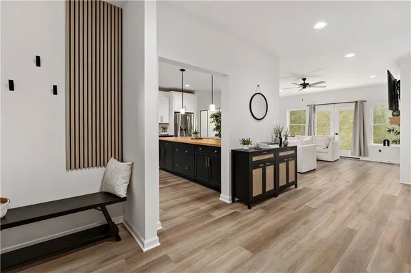a living room with furniture and a wooden floor