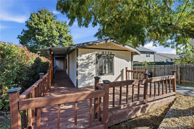 a view of a wooden chairs on the deck