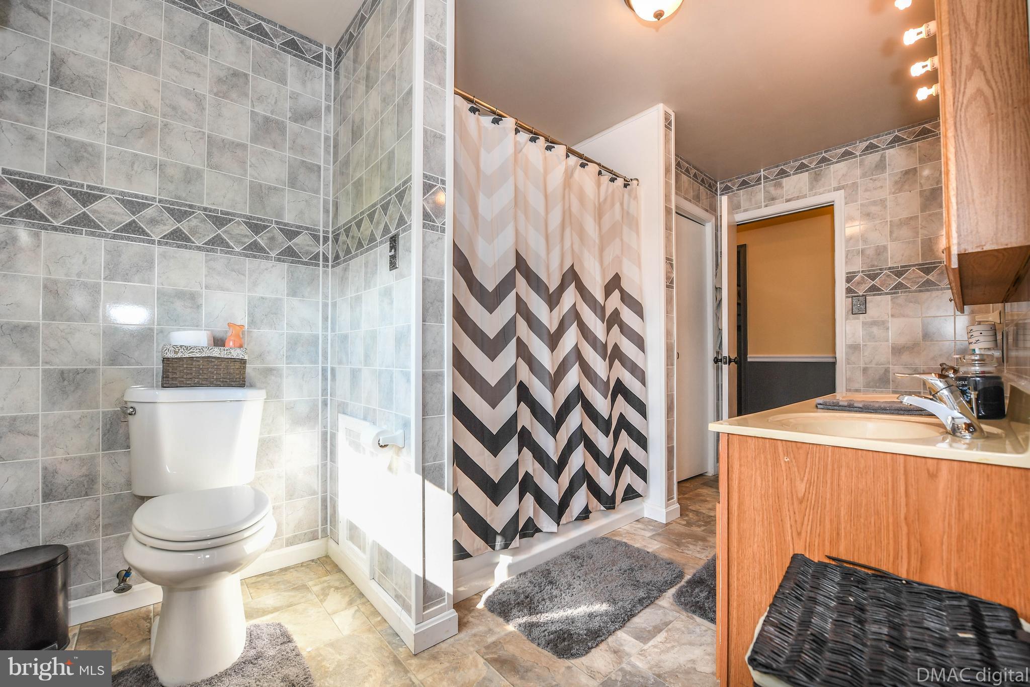 13230 Independence Road Clear Spring, MD 21722 - Photo 12 of 30 a bathroom with a sink toilet and shower