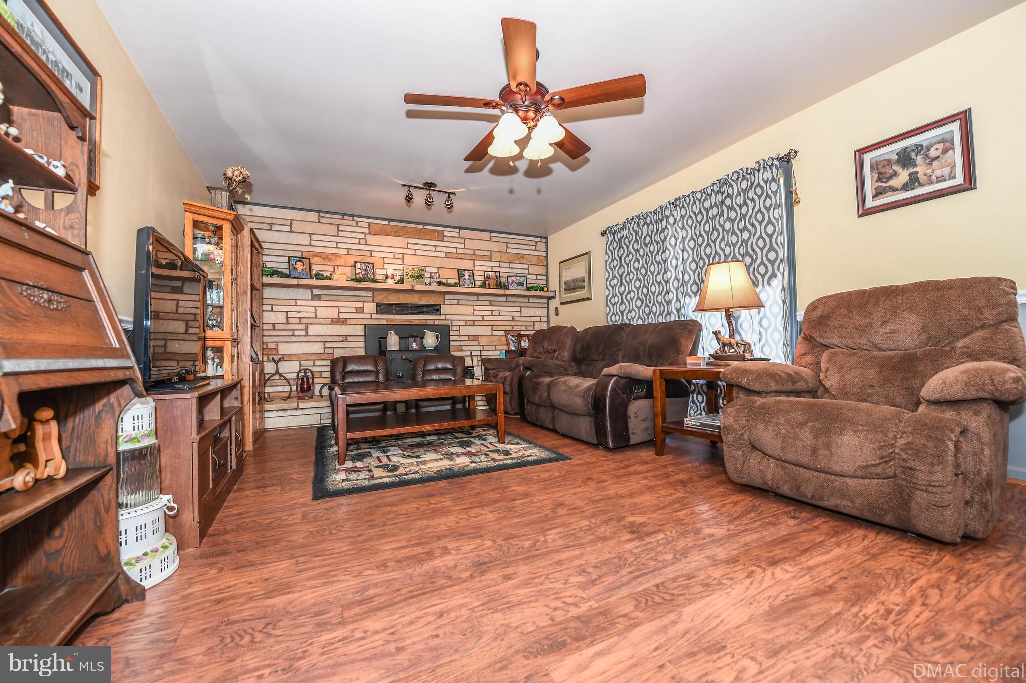13230 Independence Road Clear Spring, MD 21722 - Photo 5 of 30 a living room with furniture a flat screen tv and a fireplace