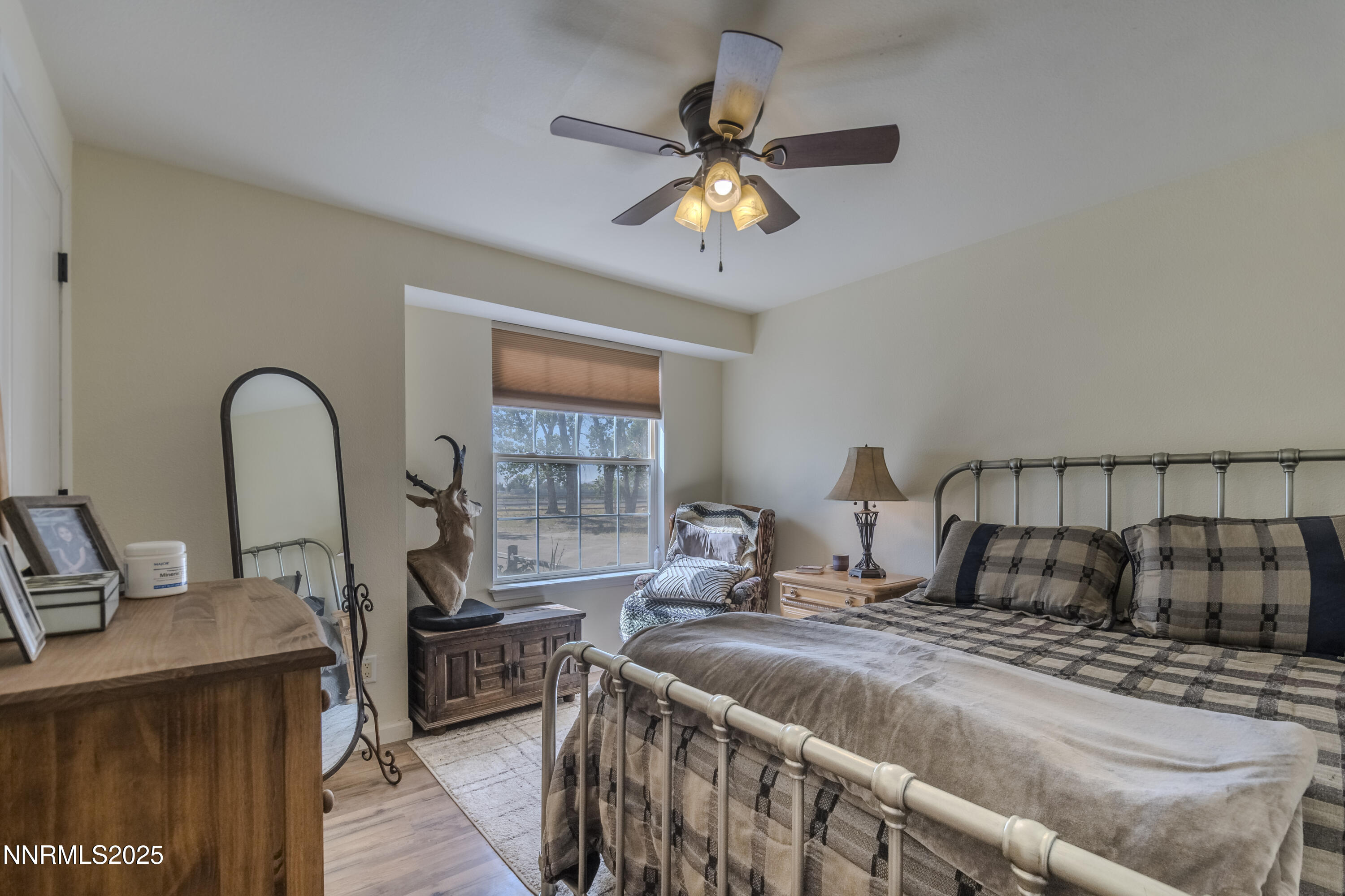 4190 Bottom Road Fallon, NV 89406 - Photo 11 of 44 a bedroom with a bed and a chandelier