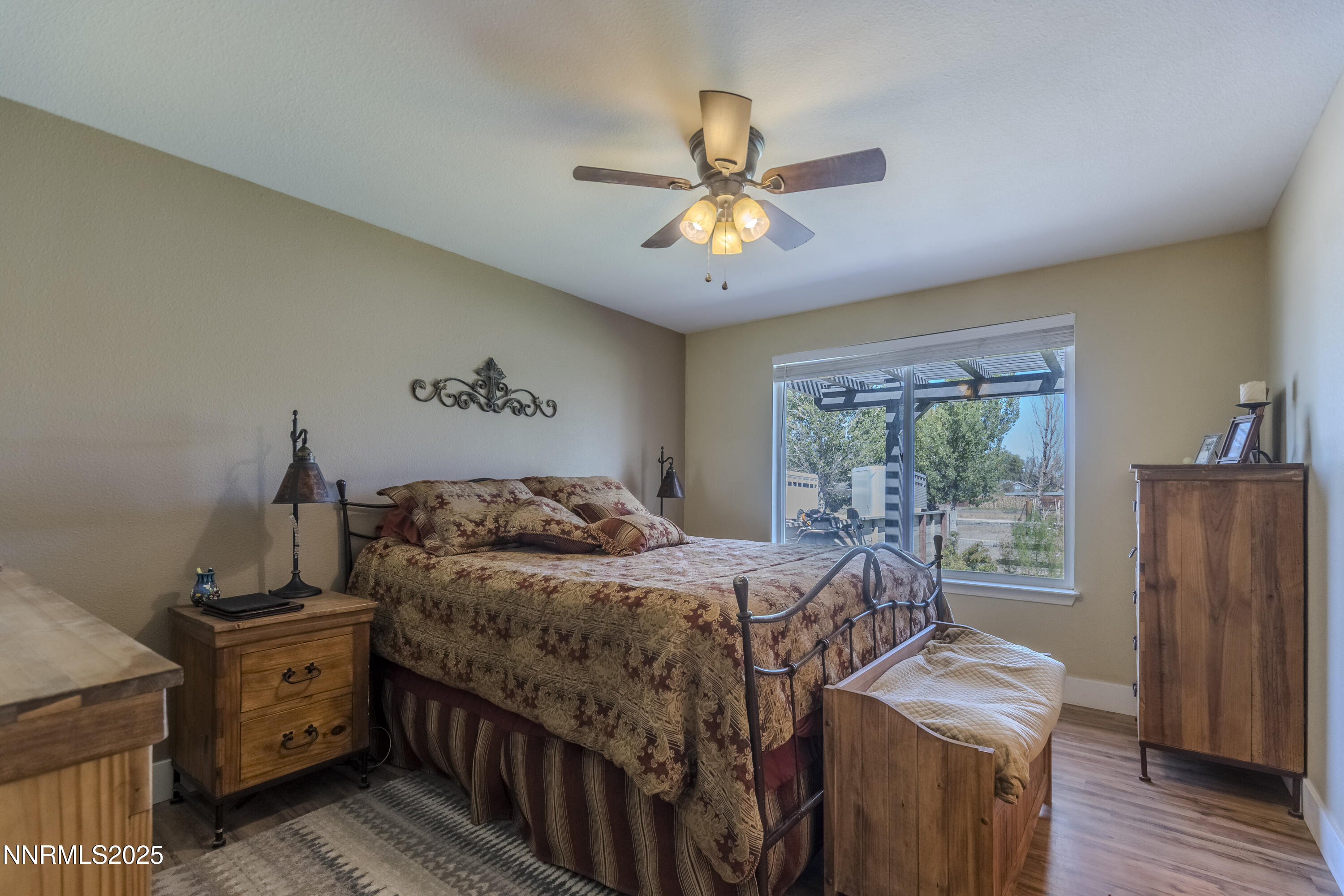 4190 Bottom Road Fallon, NV 89406 - Photo 15 of 44 a bedroom with a bed and a chandelier