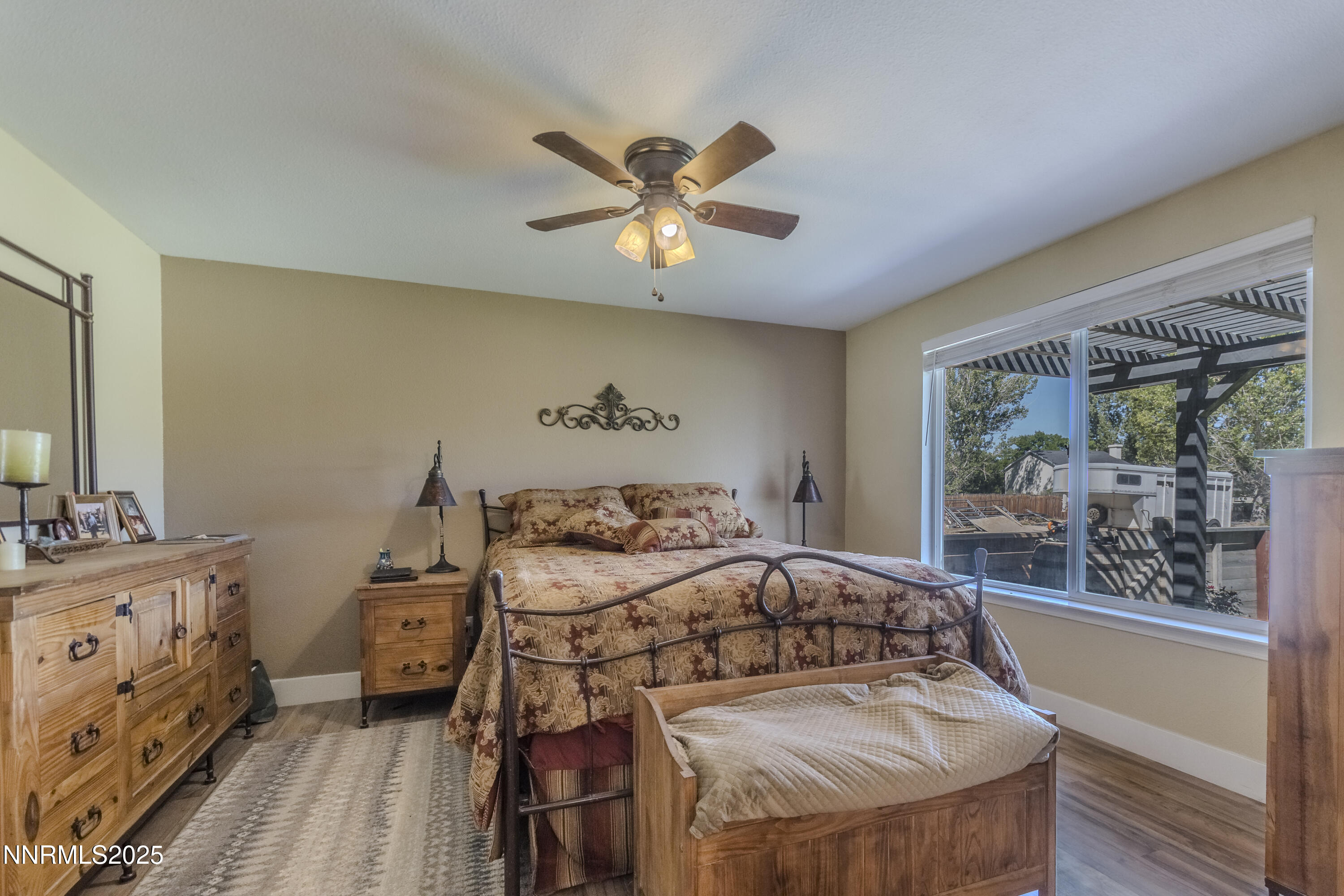 4190 Bottom Road Fallon, NV 89406 - Photo 16 of 44 a bedroom with a bed and a chandelier