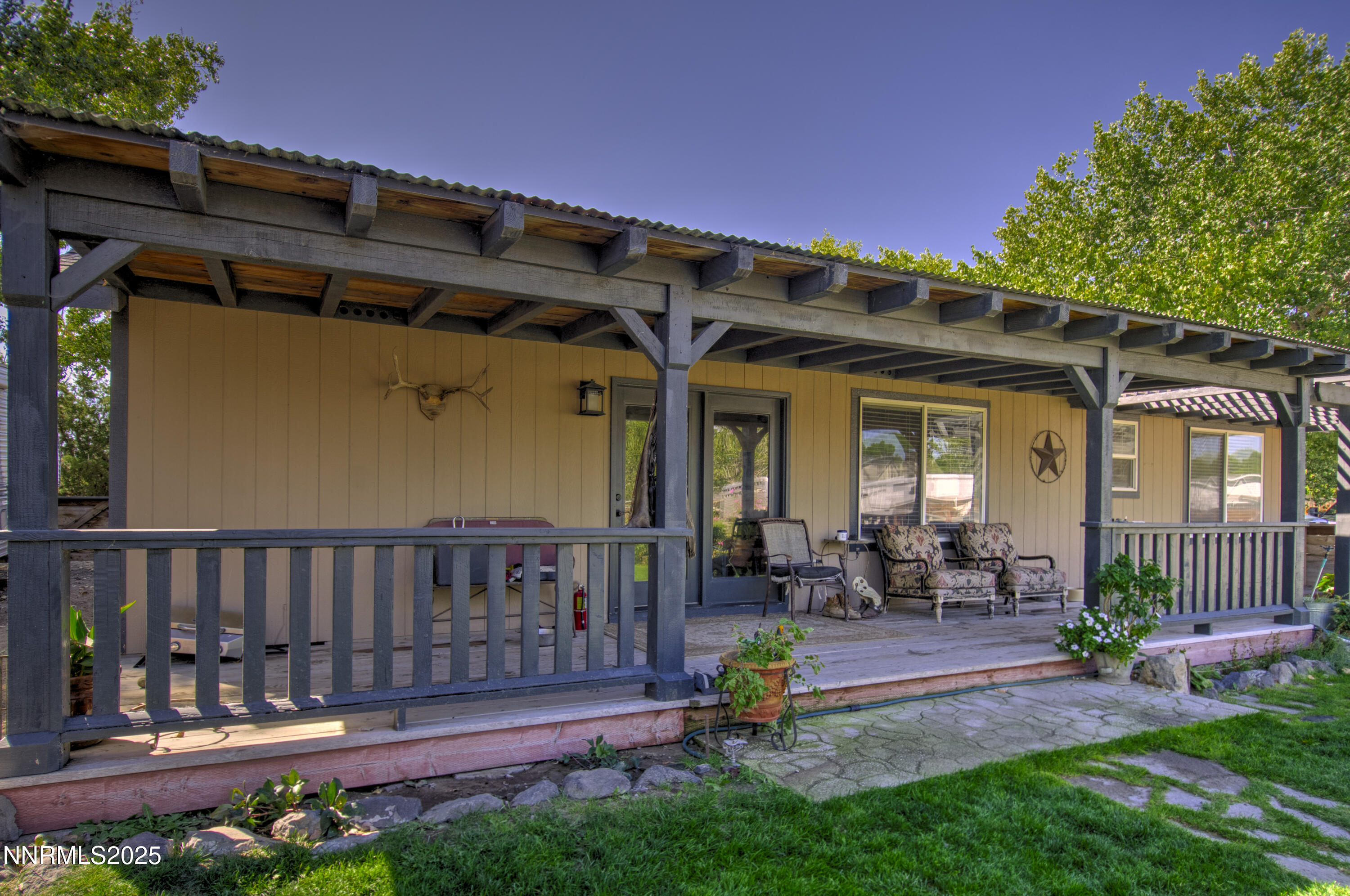 4190 Bottom Road Fallon, NV 89406 - Photo 24 of 44 a view of a chair and tables in the back yard of the house