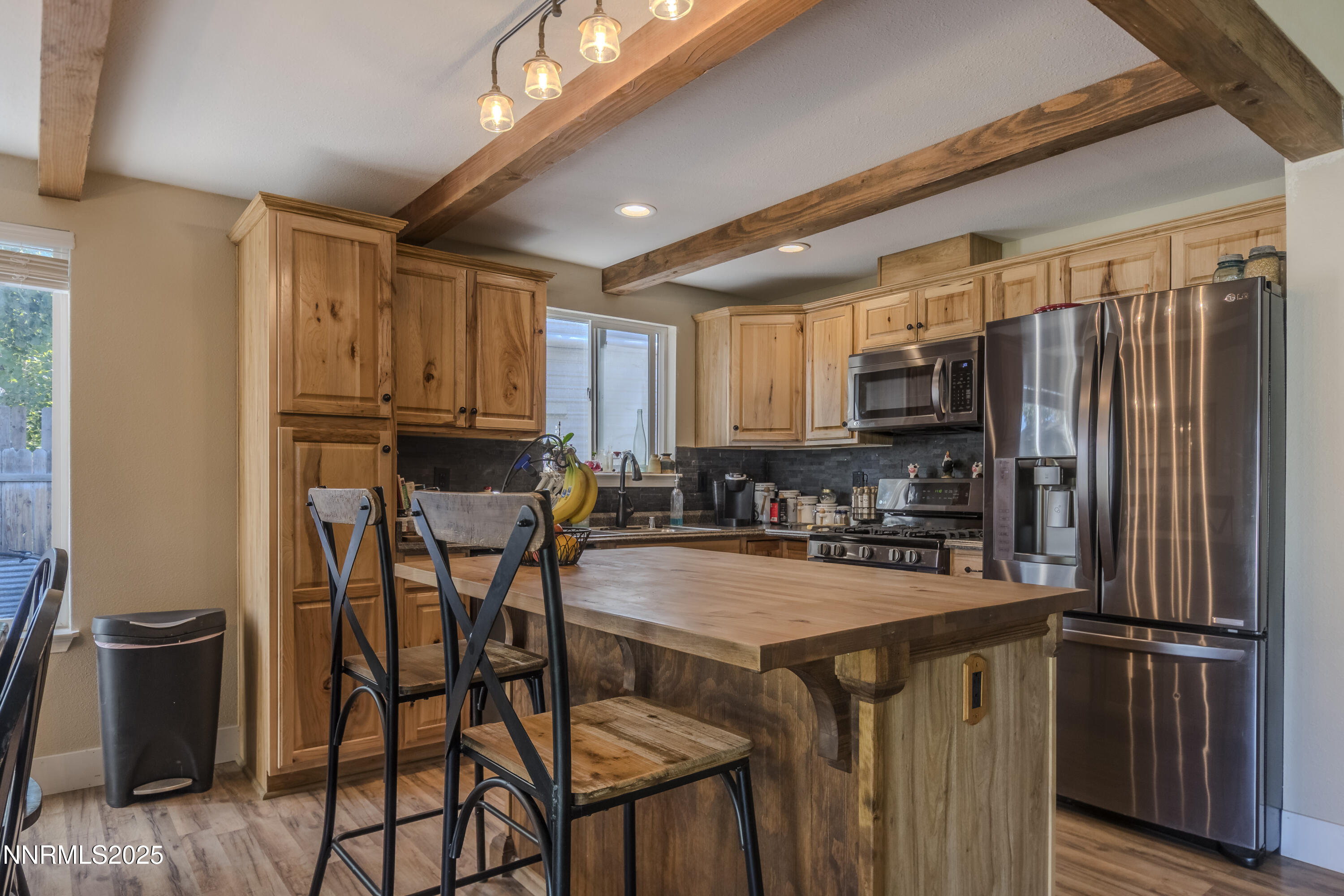 4190 Bottom Road Fallon, NV 89406 - Photo 8 of 44 a kitchen with stainless steel appliances granite countertop a stove a refrigerator a sink dishwasher and white cabinets with wooden floor
