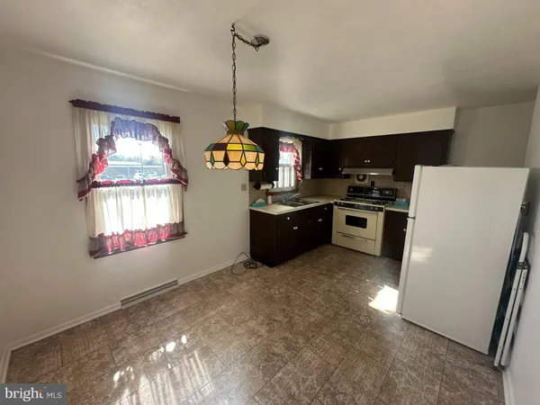 a kitchen with refrigerator and window