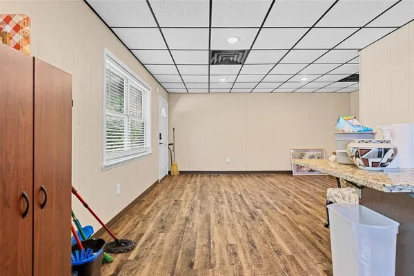 a kitchen with stainless steel appliances granite countertop a sink a stove and a wooden floor