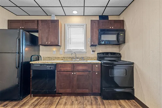 a kitchen with a sink stove and refrigerator