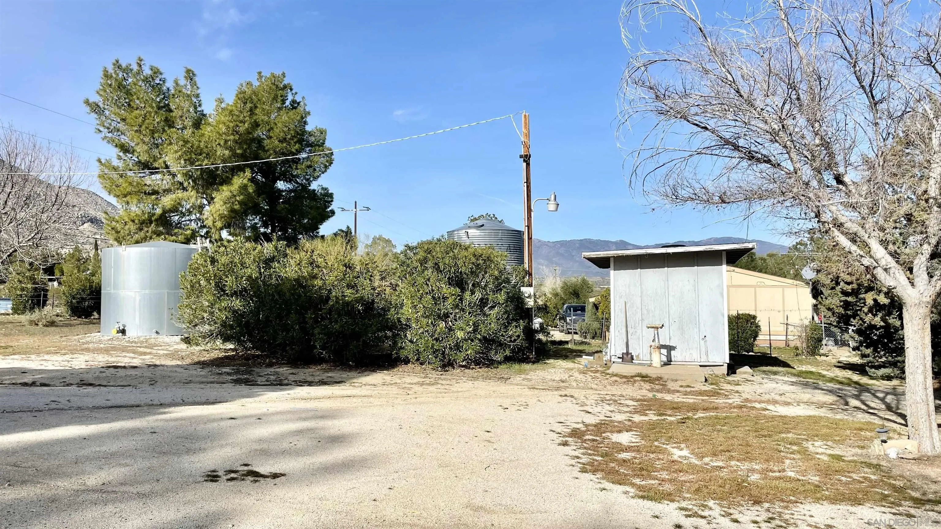 764 Surrey Trail Julian, CA 92036 - Photo 14 of 15 a view of a white house with a yard
