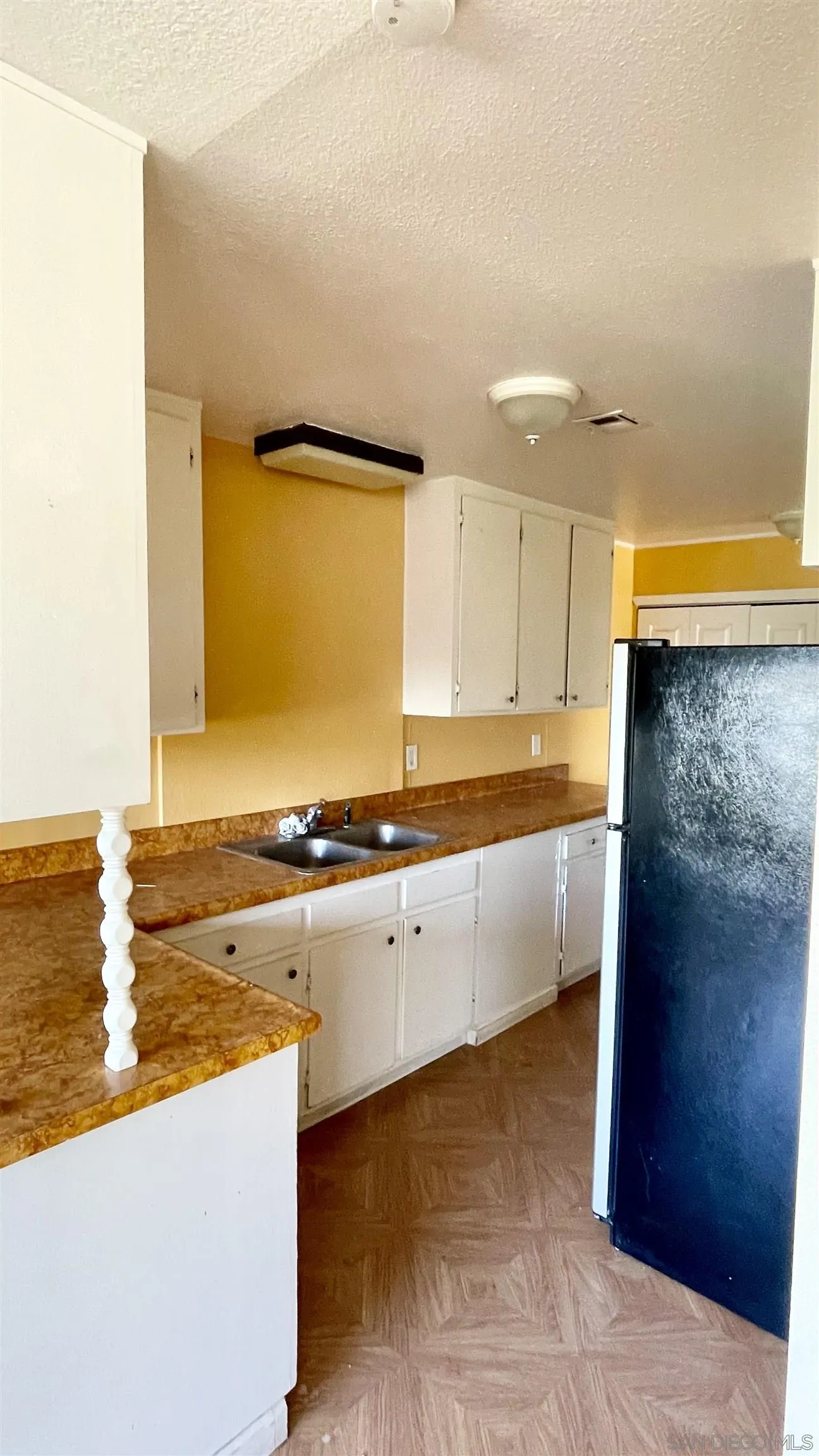 764 Surrey Trail Julian, CA 92036 - Photo 15 of 15 a large white kitchen with stainless steel appliances granite countertop a sink and cabinets