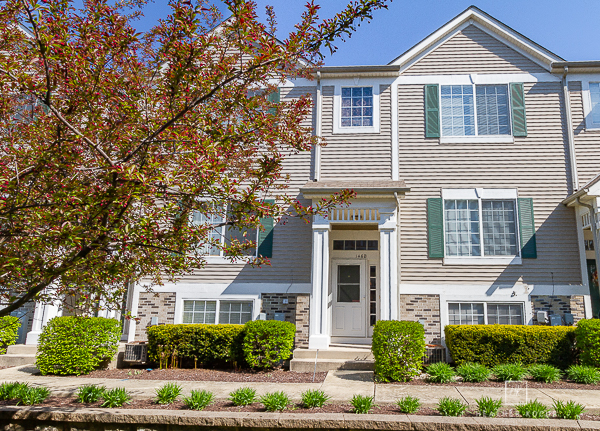 146 Enclave Circle, Unit D Bolingbrook, IL 60440 - Photo 2 of 33 front view of a house with a yard
