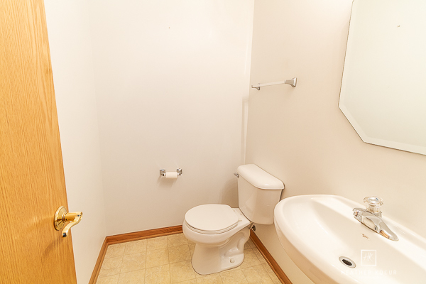 146 Enclave Circle, Unit D Bolingbrook, IL 60440 - Photo 14 of 33 a white toilet sitting next to a bathroom sink
