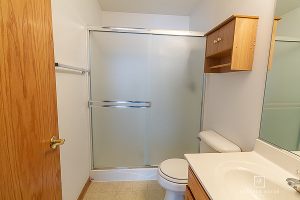 146 Enclave Circle, Unit D Bolingbrook, IL 60440 - Photo 19 of 33 a white toilet sitting next to a bathroom sink