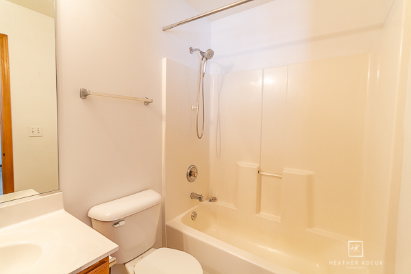 146 Enclave Circle, Unit D Bolingbrook, IL 60440 - Photo 22 of 33 a bathroom with a granite countertop bathtub shower sink vanity and toilet