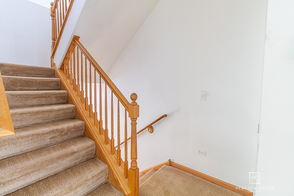 146 Enclave Circle, Unit D Bolingbrook, IL 60440 - Photo 29 of 33 a view of staircase with wooden floor and white walls