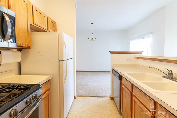 146 Enclave Circle, Unit D Bolingbrook, IL 60440 - Photo 5 of 33 a kitchen with a sink stove and refrigerator