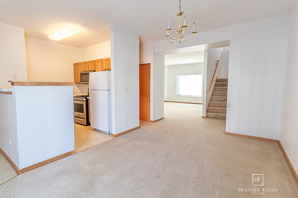 146 Enclave Circle, Unit D Bolingbrook, IL 60440 - Photo 6 of 33 a view of a hallway with a kitchen