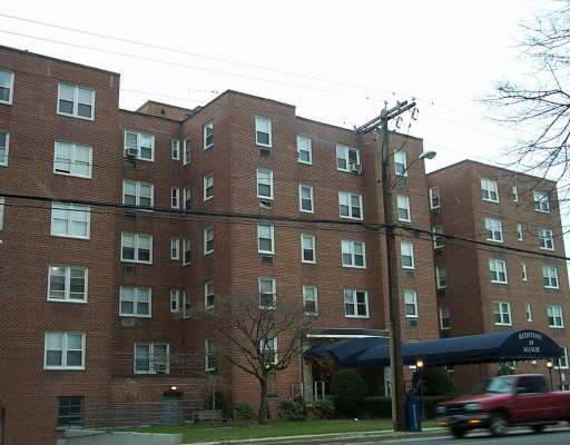 39 Glenbrook Road, Unit 10 Stamford, CT 06902 - Photo 1 of 1 a front view of a building with lot of cars and trees