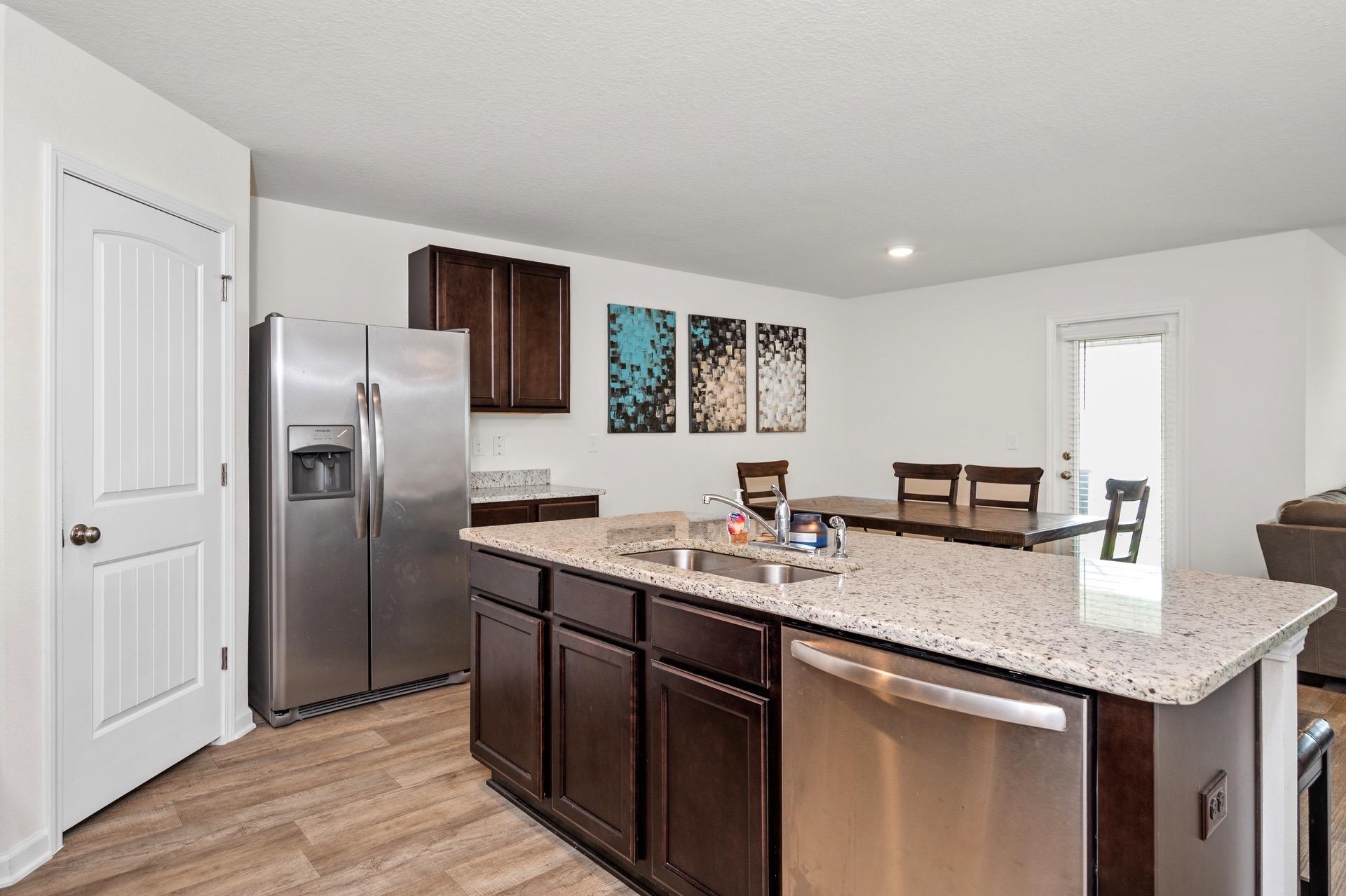 816 Moorhen Way Crestview, FL 32539 - Photo 12 of 22 a kitchen with stainless steel appliances granite countertop a sink stove and refrigerator