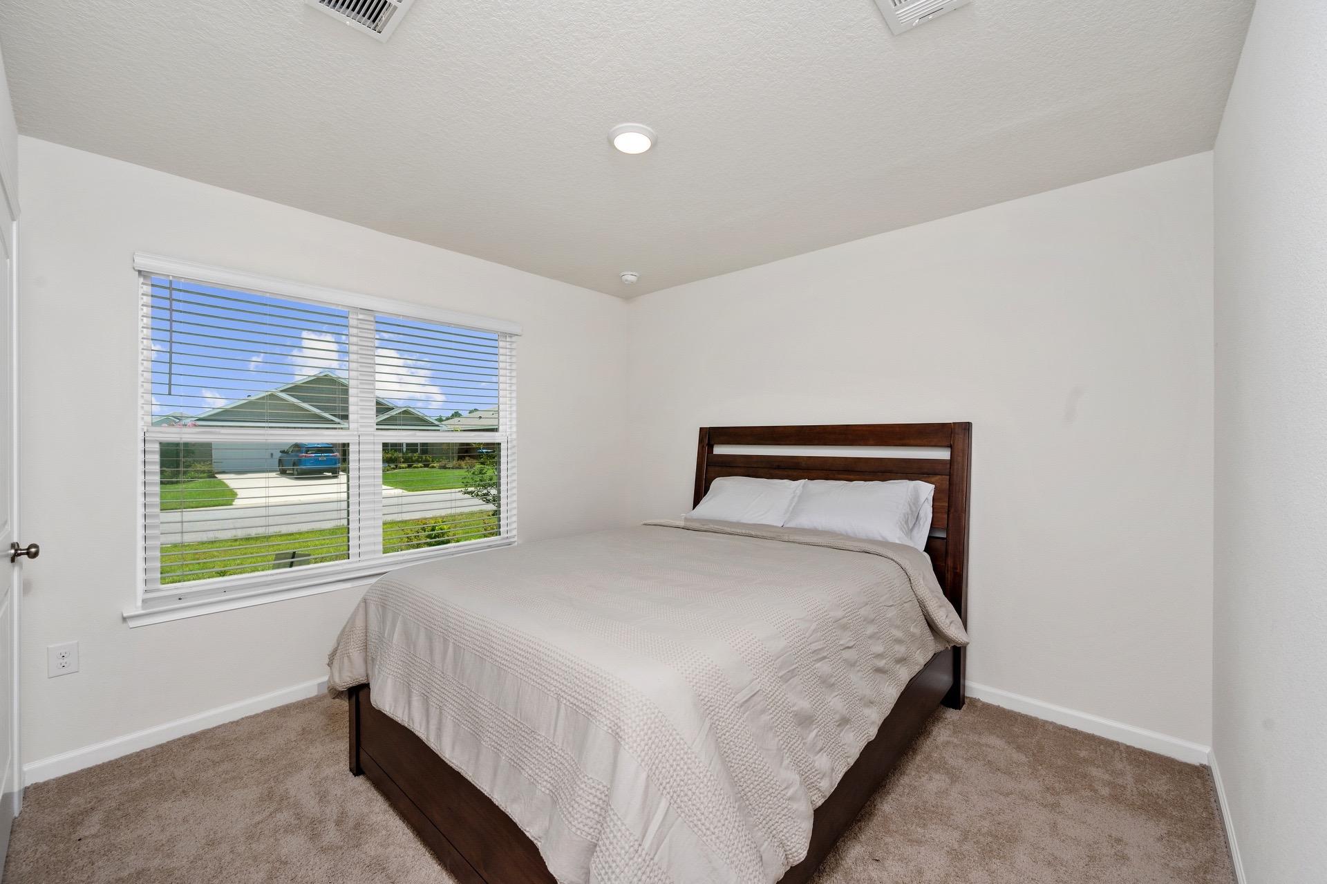 816 Moorhen Way Crestview, FL 32539 - Photo 19 of 22 a bed sitting in a bedroom next to a window