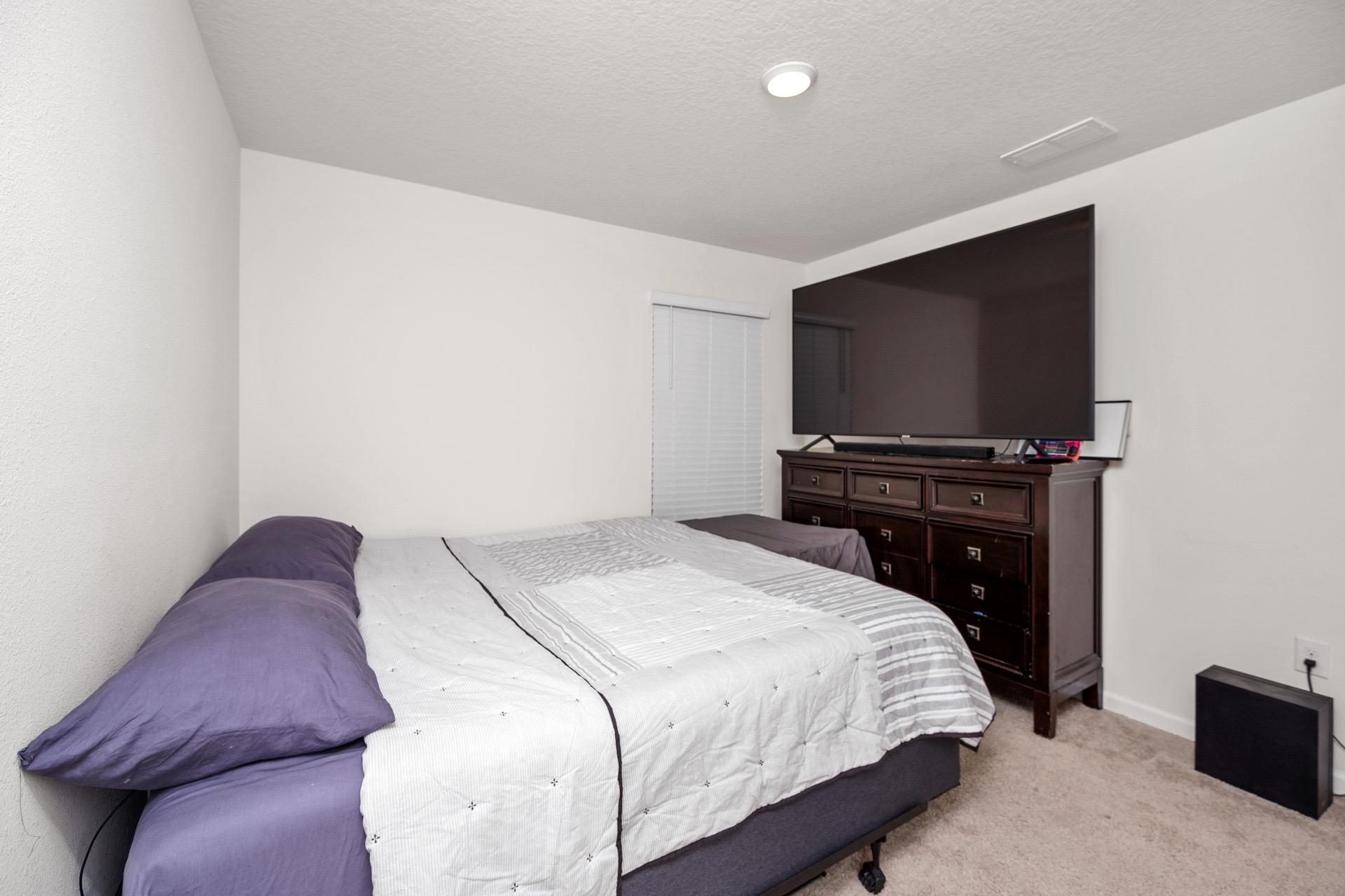 816 Moorhen Way Crestview, FL 32539 - Photo 21 of 22 a bedroom with a bed and a flat screen tv