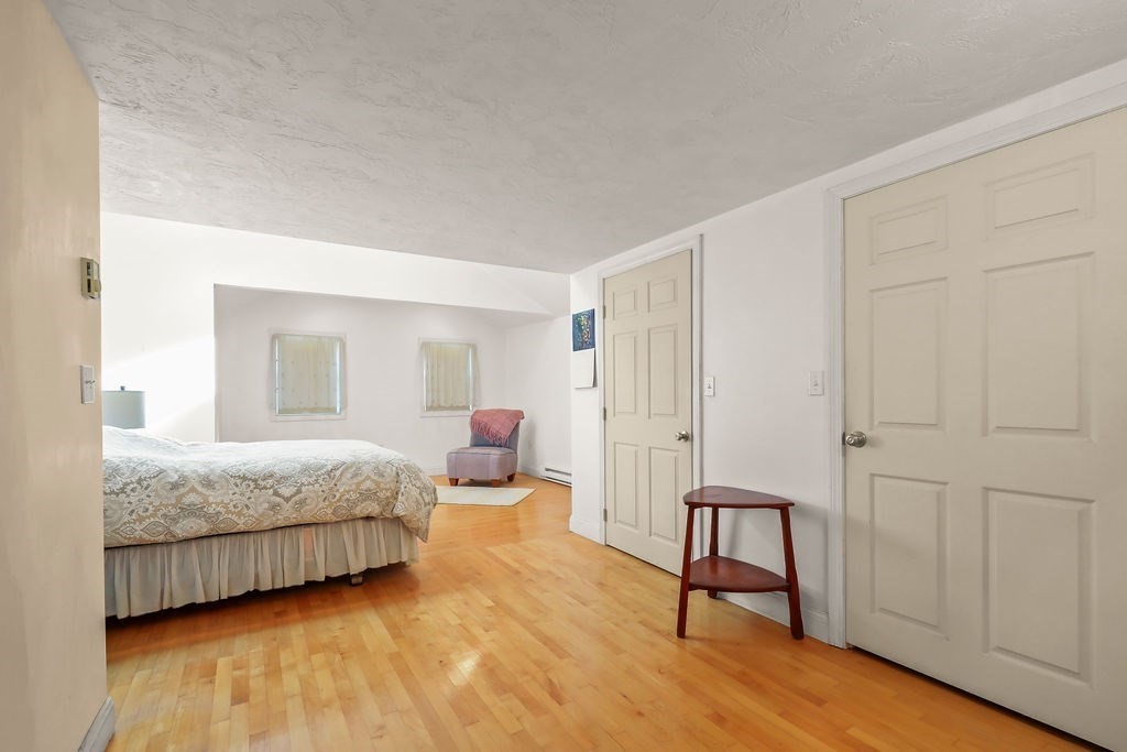 94 Fearing Hill Road Wareham, MA 02576 - Photo 8 of 41 a spacious bedroom with a bed and a lamp