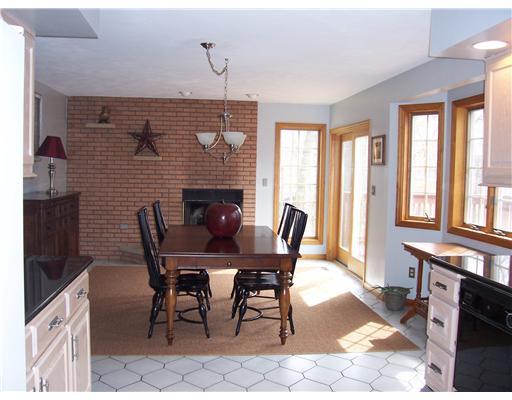 122 Harbison Road Valencia, PA 16059 - Photo 8 of 18 Dining Room. The Spacious Dining room features patio doors to the to the Deck and lots of windows - the large Fireplace and brick design add warmth and style