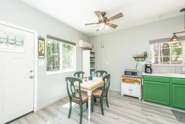 a dining room with a wooden table and chairs