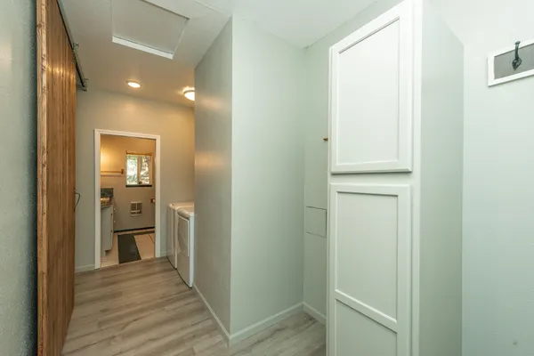 a view of a hallway with wooden floor