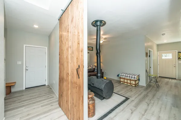 a view of a hallway with wooden floor and closet