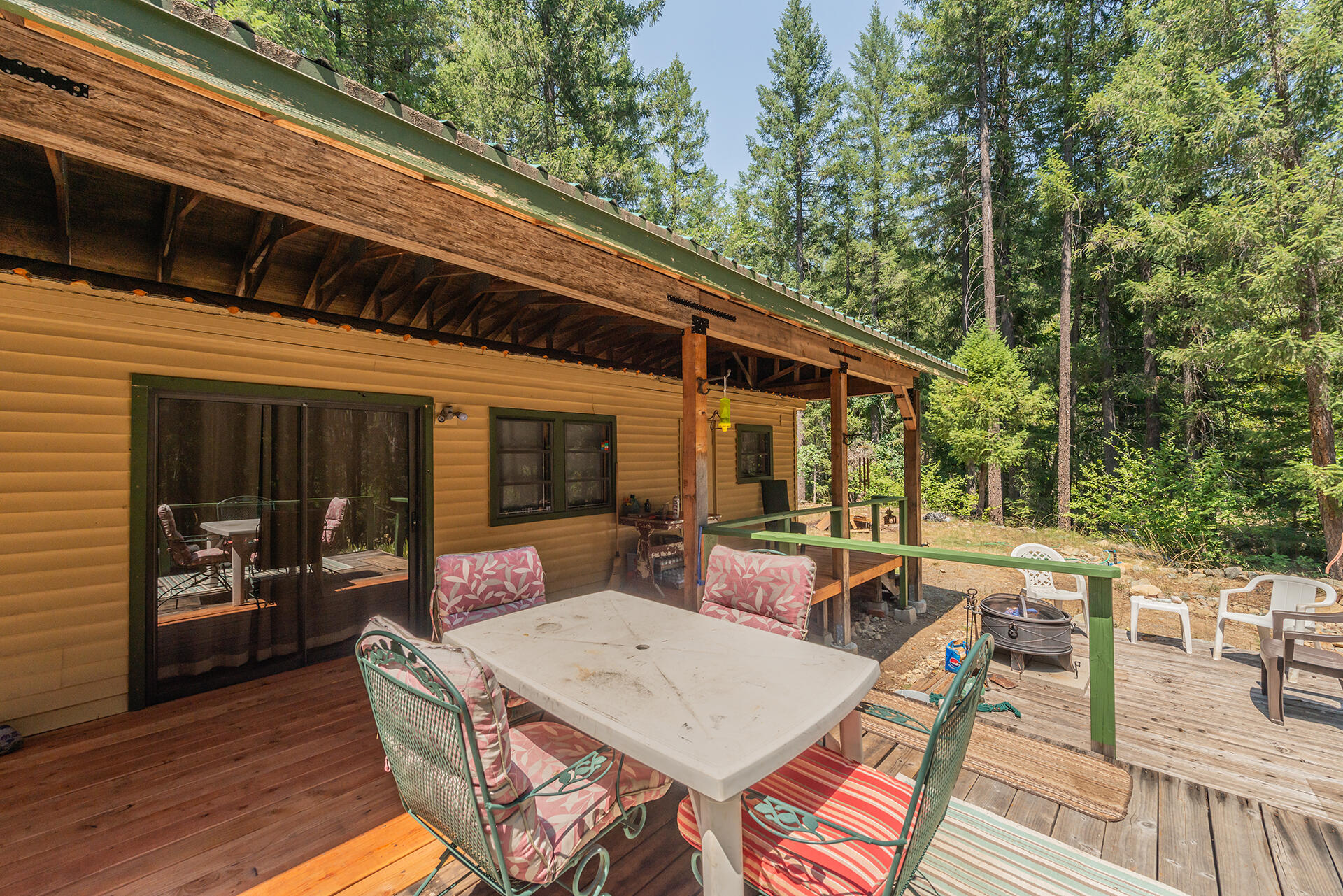 1371 Eagle Creek Loop Trinity Center, CA 96091 - Photo 27 of 37 a view of a patio with table and chairs with wooden floor and fence