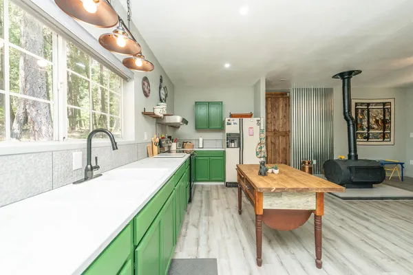 a large kitchen with a table and chairs