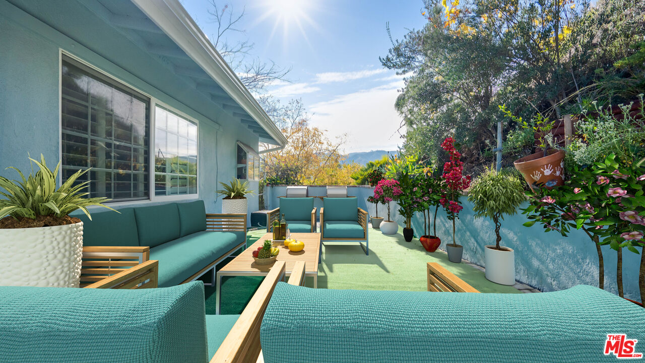 a view of a chairs and table in the balcony