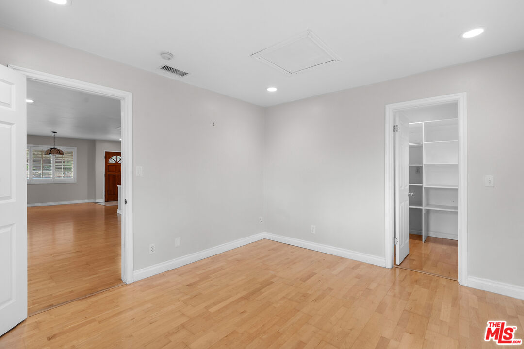 9631 Crystal View Drive Tujunga, CA 91042 - Photo 15 of 37 a view of a hallway with wooden floor and a bathroom