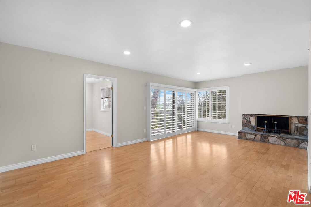 9631 Crystal View Drive Tujunga, CA 91042 - Photo 19 of 37 a view of an empty room with a window and wooden floor