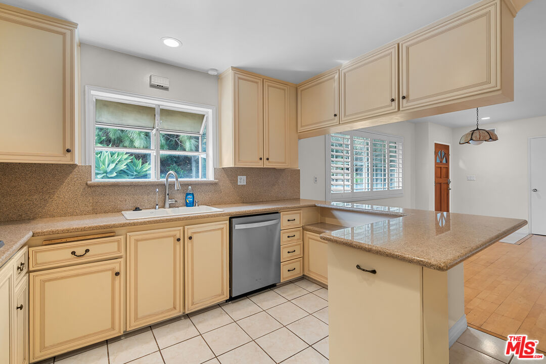 9631 Crystal View Drive Tujunga, CA 91042 - Photo 24 of 37 a kitchen with white cabinets appliances a sink and a window