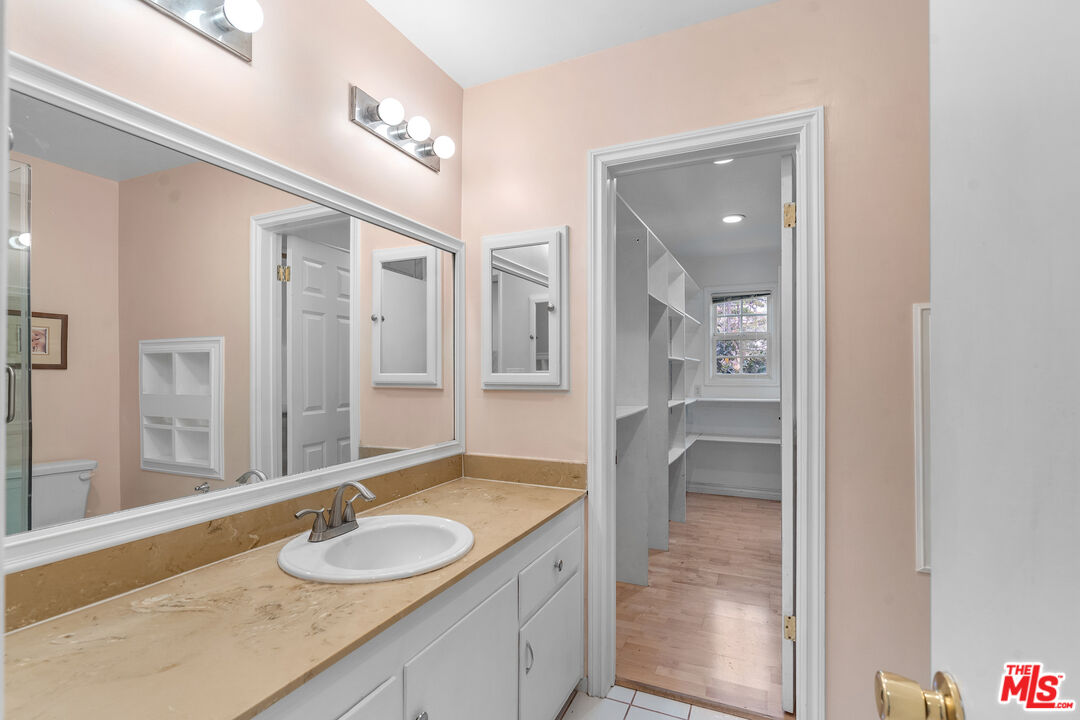 9631 Crystal View Drive Tujunga, CA 91042 - Photo 32 of 37 a bathroom with a granite countertop sink and a mirror