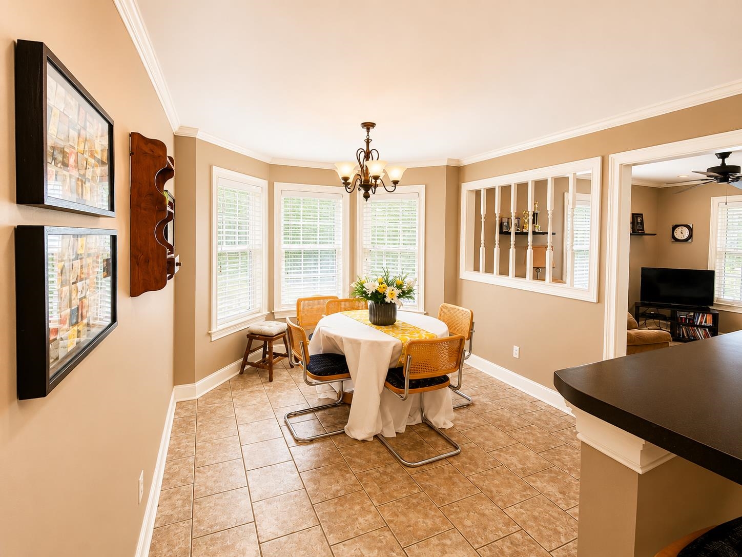 59 Conner Circle Iuka, MS 38852 - Photo 13 of 20 Bay window dining area featuring tile flooring, a chandelier, and crown molding