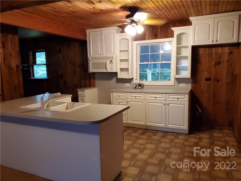 4401 Poplar Tent Road Concord, NC 28027 - Photo 5 of 16 a kitchen with a sink stove and cabinets