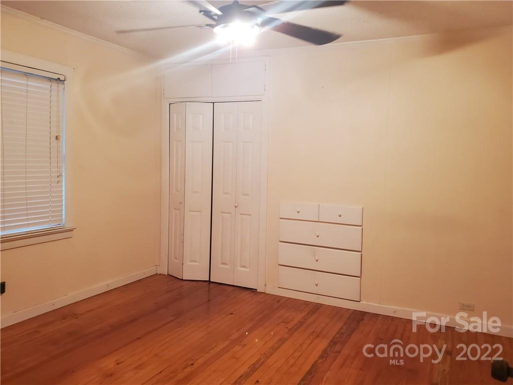4401 Poplar Tent Road Concord, NC 28027 - Photo 10 of 16 an empty room with wooden floor