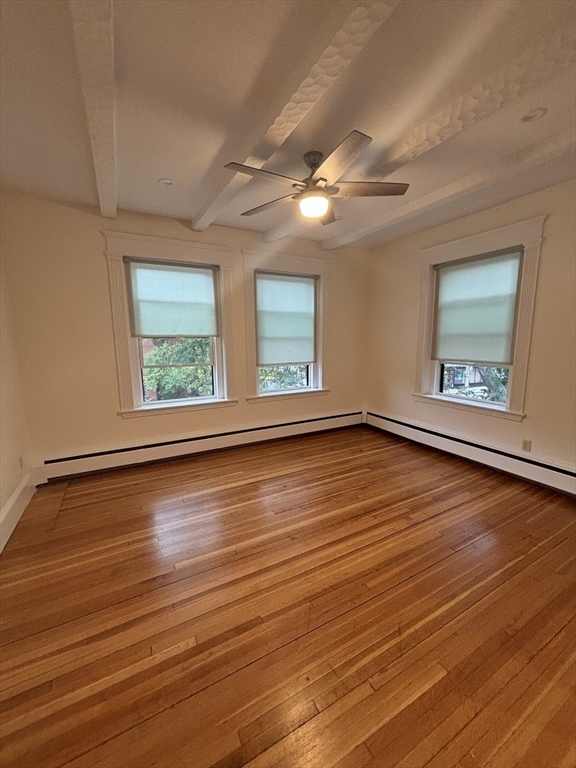 503 Park Drive, Unit 6 Boston, MA 02215 - Photo 3 of 9 an empty room with wooden floor and windows